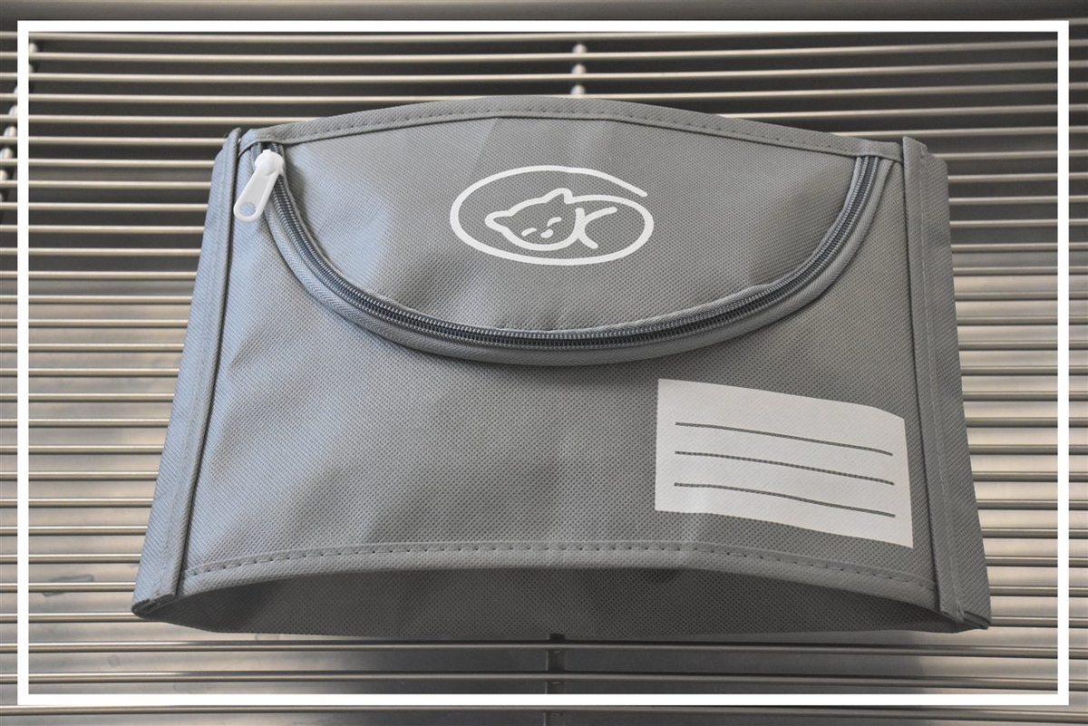 A grey Euthabag pet burial bag with a soft zip and a name label panel